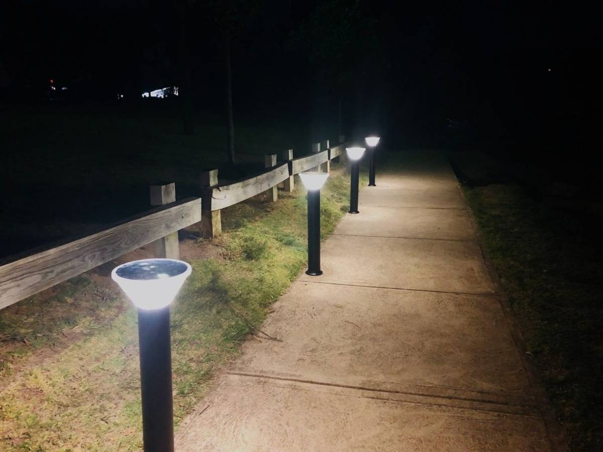 commercial LED solar bollard pathway lights illuminating a path at night